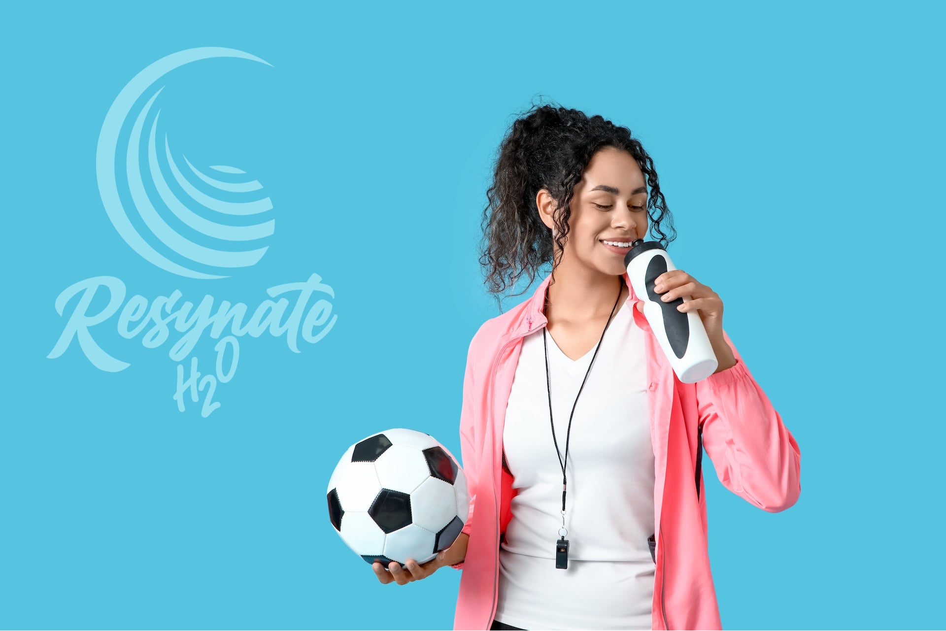 Female athlete drinking water holding soccer ball using Resynate H2O electrolyte powder for hydration and performance